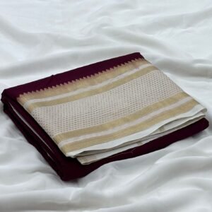 a folded fabric on a white sheetPremium Mysore silk saree In Coffee Brown With White