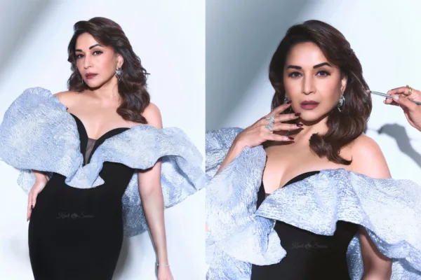 Madhuri Dixit Nene wearing a black evening gown with dramatic metallic ruffle shoulders and statement diamond earrings on the red carpet.